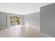 Spacious living room with wood-look floors and access to balcony at 4215 E Bay Dr # 1105C, Clearwater, FL 33764