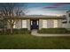 Tan house with white shutters, black door, and well-manicured lawn at 4307 W San Pedro St, Tampa, FL 33629