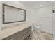 Modern bathroom with gray vanity and marble countertop at 4720 Brittany S Dr # 140, St Petersburg, FL 33715