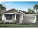 One-story home with gray siding, stone accents, and a two-car garage at 5029 124Th E Ave, Parrish, FL 34219