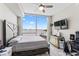 Bedroom with water views, a large bed, and a dresser at 5120 Marina Way # 2208, Tampa, FL 33611