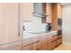 Modern kitchen with light wood cabinets, stainless steel appliances, and a sleek countertop at 5120 Marina Way # 2208, Tampa, FL 33611