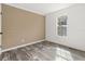 Well-lit bedroom with wood-look floors and neutral walls at 5234 Yellow Pine N St, St Petersburg, FL 33709