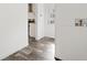 Hallway with wood-look floors and access to kitchen and exterior at 5234 Yellow Pine N St, St Petersburg, FL 33709