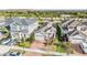 Aerial perspective showcasing three houses with attached garages and well-manicured lawns at 5613 Del Coronado Dr, Apollo Beach, FL 33572