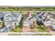 Aerial view of a house with a two-car garage and a brick driveway at 5613 Del Coronado Dr, Apollo Beach, FL 33572