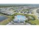 Aerial view of community pool, clubhouse, and surrounding neighborhood at 5613 Del Coronado Dr, Apollo Beach, FL 33572