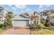 Two-story home with gray siding, brick driveway, and landscaping at 5613 Del Coronado Dr, Apollo Beach, FL 33572