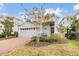 Two-story home with gray siding, brick driveway, and landscaping at 5613 Del Coronado Dr, Apollo Beach, FL 33572