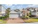 Charming house with gray siding, red door, and brick driveway at 5613 Del Coronado Dr, Apollo Beach, FL 33572