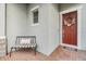 Red front door with wreath and black metal bench at 5613 Del Coronado Dr, Apollo Beach, FL 33572