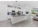 Modern kitchen with white cabinets, grey countertops, and island at 5613 Del Coronado Dr, Apollo Beach, FL 33572