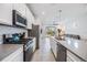 Modern kitchen featuring stainless steel appliances and an island at 5613 Del Coronado Dr, Apollo Beach, FL 33572