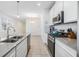 Modern kitchen with white cabinets and stainless steel appliances at 5613 Del Coronado Dr, Apollo Beach, FL 33572