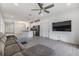 Open living room with gray sectional sofa, kitchen island, and large TV at 5613 Del Coronado Dr, Apollo Beach, FL 33572