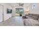 Living room with gray sectional sofa and sliding glass doors at 5613 Del Coronado Dr, Apollo Beach, FL 33572
