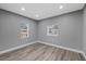 Bedroom with two windows and wood-look floors at 706 N Castle Ct, Tampa, FL 33612