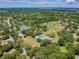 Aerial view of community pool and tennis courts at 775 Rolling Hills Dr, Palm Harbor, FL 34683