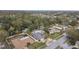 Residential neighborhood with mature trees and various home styles at 775 Rolling Hills Dr, Palm Harbor, FL 34683
