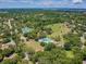 Aerial view showing community pool and tennis courts at 775 Rolling Hills Dr, Palm Harbor, FL 34683