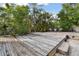 Spacious backyard with wooden deck and patio at 775 Rolling Hills Dr, Palm Harbor, FL 34683