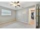 Spacious bedroom with ceiling fan and access to hallway at 775 Rolling Hills Dr, Palm Harbor, FL 34683