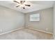 Bright bedroom with ceiling fan and carpeted floors at 775 Rolling Hills Dr, Palm Harbor, FL 34683