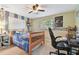 bedroom with twin bed, desk, and built-in shelving at 775 Rolling Hills Dr, Palm Harbor, FL 34683