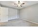 Bedroom with ceiling fan, closet, and carpeted floor at 775 Rolling Hills Dr, Palm Harbor, FL 34683