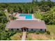 Community pool with adjacent clubhouse and lounge chairs at 775 Rolling Hills Dr, Palm Harbor, FL 34683
