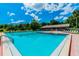 Inviting community pool with lounge chairs and a poolside building at 775 Rolling Hills Dr, Palm Harbor, FL 34683