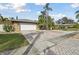 Home with white garage door and brick paver driveway at 775 Rolling Hills Dr, Palm Harbor, FL 34683