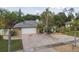 Single-story home with brick paver driveway and palm trees at 775 Rolling Hills Dr, Palm Harbor, FL 34683