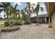 Brick paved patio area with tropical landscaping at 775 Rolling Hills Dr, Palm Harbor, FL 34683