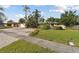 House with a large yard and brick driveway at 775 Rolling Hills Dr, Palm Harbor, FL 34683