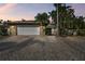 Attractive single-story home with a large driveway and lush landscaping at 775 Rolling Hills Dr, Palm Harbor, FL 34683