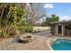 Relaxing fire pit area beside the pool at 775 Rolling Hills Dr, Palm Harbor, FL 34683