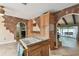 Kitchen features wood cabinets and brick accent walls at 775 Rolling Hills Dr, Palm Harbor, FL 34683