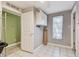 Small laundry room with white cabinets and tile floor at 775 Rolling Hills Dr, Palm Harbor, FL 34683