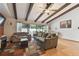 Spacious living area with hardwood floors and wood beam ceilings at 775 Rolling Hills Dr, Palm Harbor, FL 34683