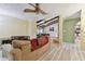 Living room with vaulted ceiling, wood beams, and view of kitchen at 775 Rolling Hills Dr, Palm Harbor, FL 34683
