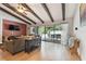 Living room with wood beams, hardwood floors and sliding doors to patio at 775 Rolling Hills Dr, Palm Harbor, FL 34683