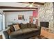 Living room with stone fireplace and wood beam ceiling at 775 Rolling Hills Dr, Palm Harbor, FL 34683