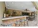 Outdoor bar with seating and view of pool area at 775 Rolling Hills Dr, Palm Harbor, FL 34683