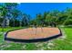 playground with swings set in a wood chip area at 775 Rolling Hills Dr, Palm Harbor, FL 34683