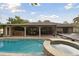 Inviting pool area with spa and covered patio at 775 Rolling Hills Dr, Palm Harbor, FL 34683
