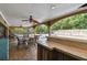Covered patio with pool view, dining area, and bar at 775 Rolling Hills Dr, Palm Harbor, FL 34683
