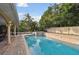 Inviting pool with brick patio and hot tub at 775 Rolling Hills Dr, Palm Harbor, FL 34683