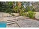 Brick patio steps leading to the pool at 775 Rolling Hills Dr, Palm Harbor, FL 34683