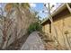 Paved walkway alongside home and garden at 775 Rolling Hills Dr, Palm Harbor, FL 34683